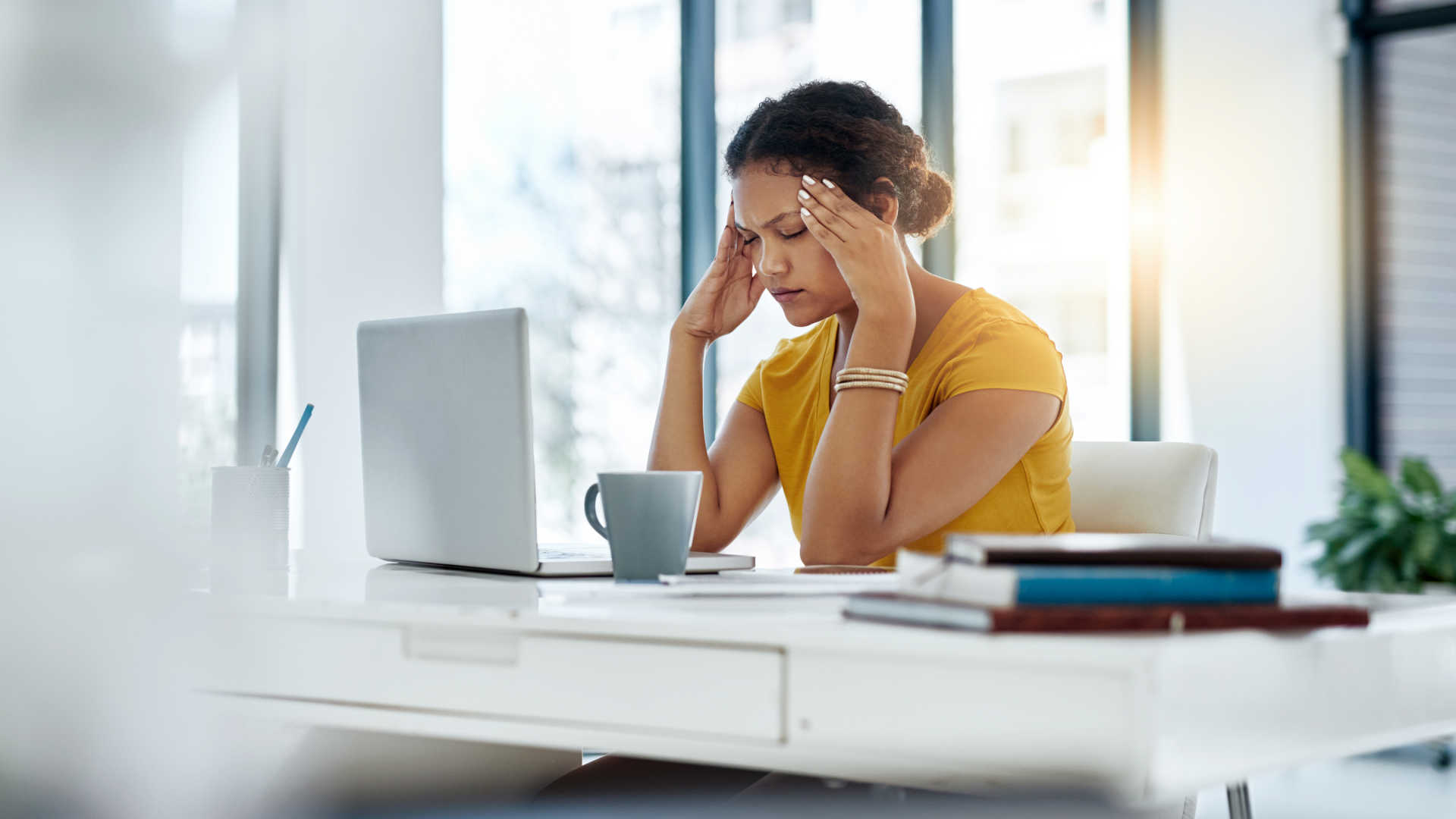 Woman looking tired and overwhelmed by daily stress and emotional challenges affecting her mental wellness