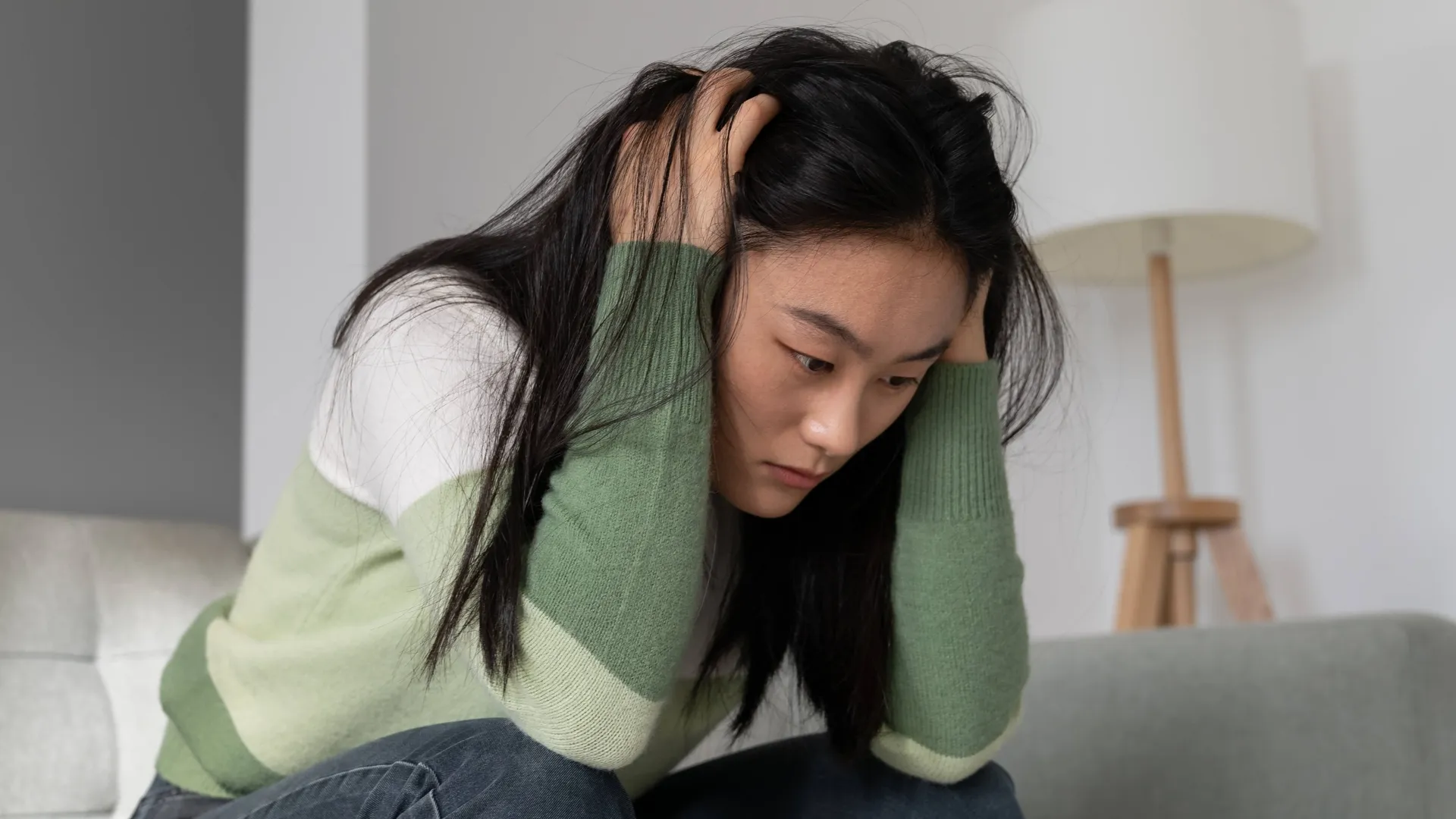 Woman looking stressed and overwhelmed while coping with anxiety, daily pressures, and emotional challenges