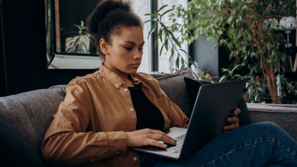 Woman holding a laptop during a virtual session to access convenient online psychiatric services and professional support