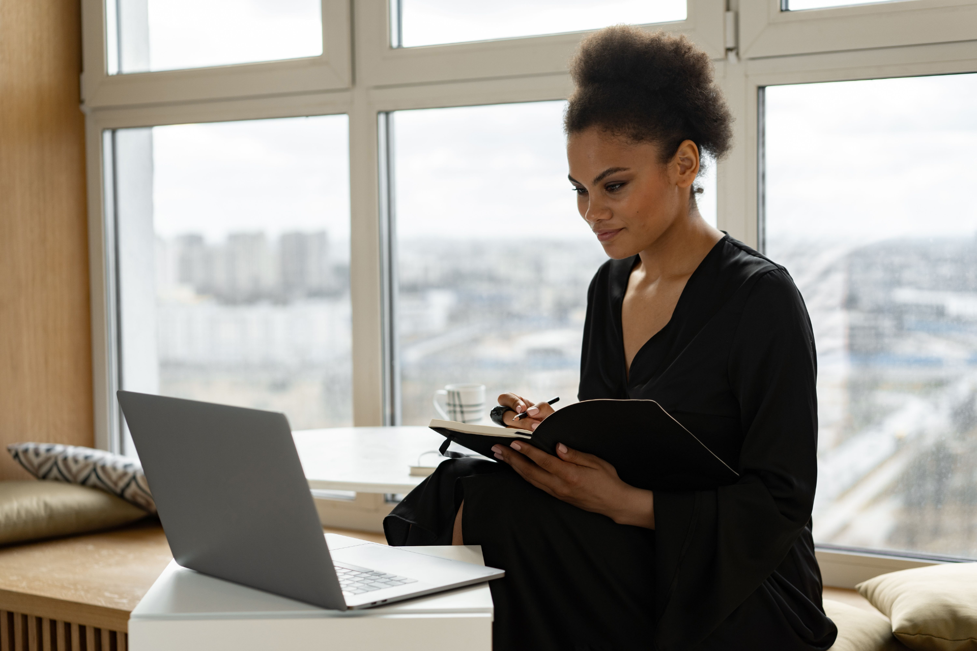 Mental health professional taking notes during a client’s medication management appointment in a clinical setting