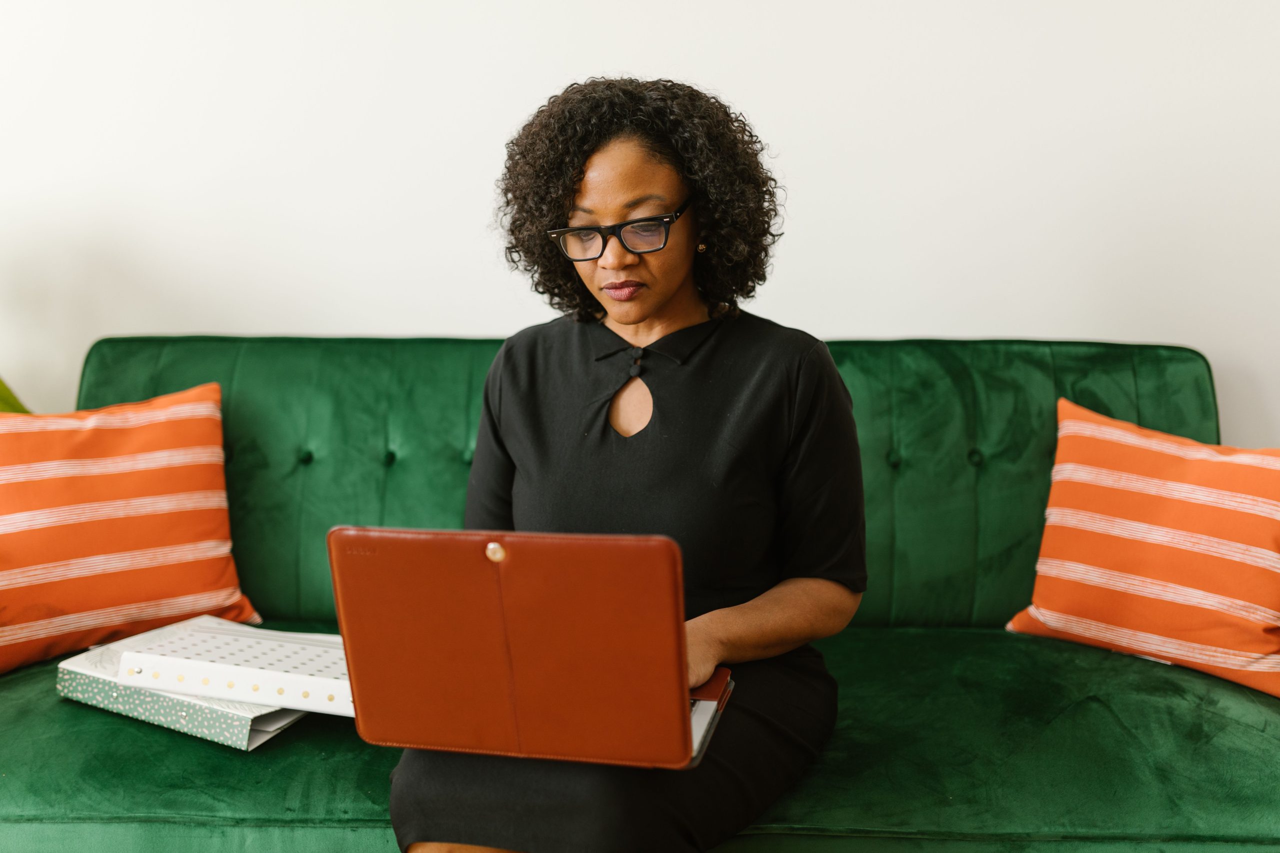 Nurse using a laptop to coordinate virtual psychiatric visits and help patients access online mental health care